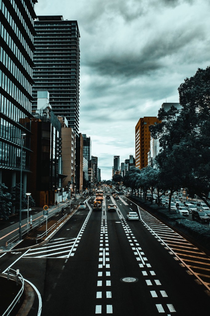 Aerial view of a city street with buildings and traffic